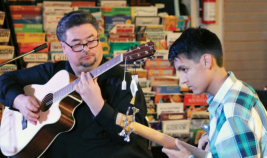 Wayne Hoover, owner of Quality Music and Dance, accompanying a student, Gabriel.