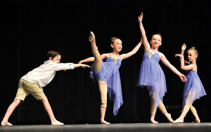 Students of Quality Music and Dance performing on stage. From left: Nick, Olivia, Ava and Faith.