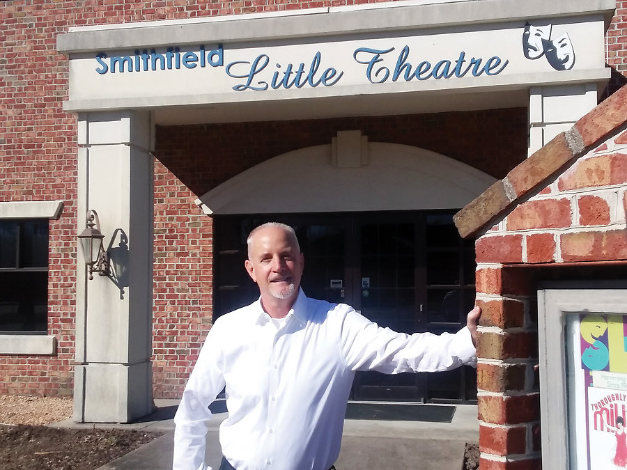 Mark Hall poses in front of Smithfield Little Theatreâ€™s beautiful state-of-the-art facility.