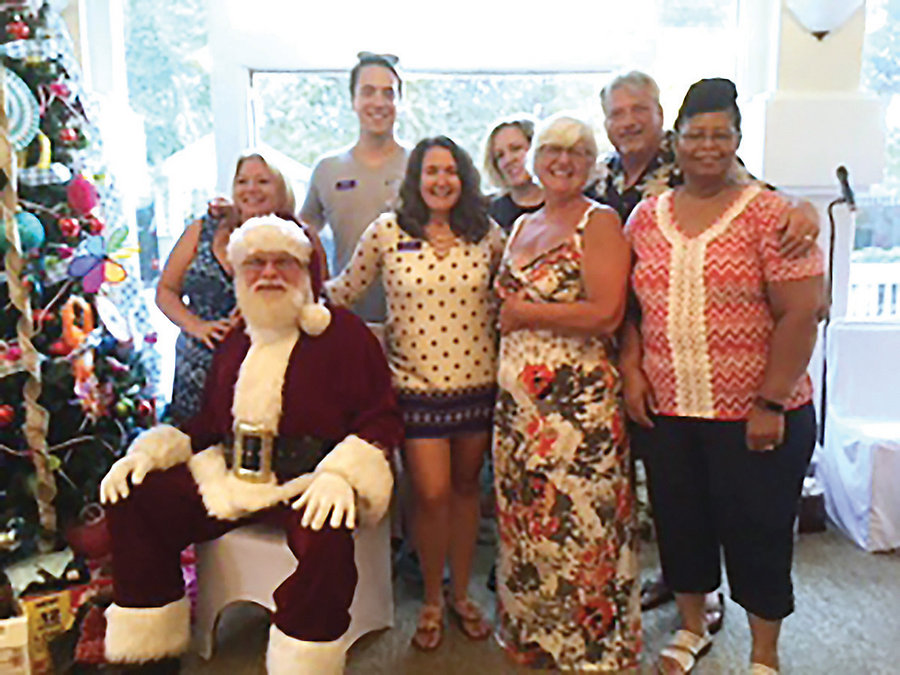 From left to right: Stella McClain, Santa Claus, Wynn Horton, Beth Cross, Stephanie Gray, Connie Hedrick, Steve Hedrick and Gladys Jones at a previous Christmas in July.