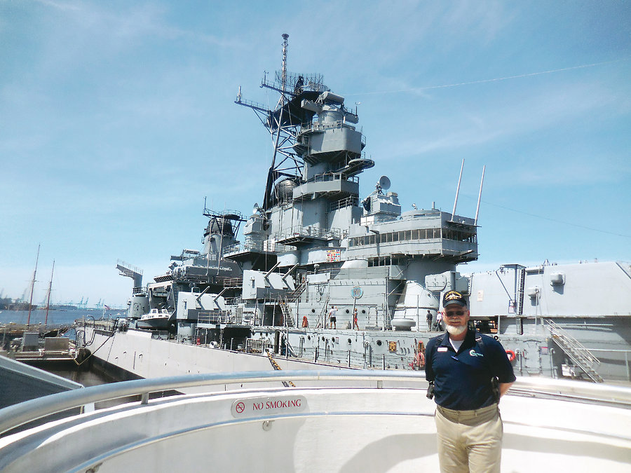 Battleship Operations Manager Clayton Allen in front of the Wisconsin 