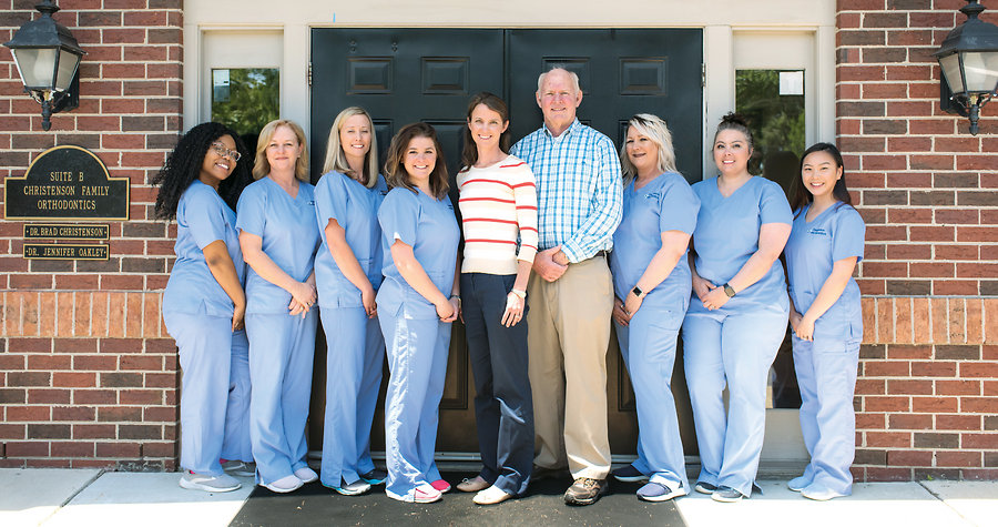 The daughter/father duo of Dr. Jennifer Oakley and Dr. Brad Christenson (center) <BR>head the staff  of Christenson Family Orthodontics      <BR>  Photo by Michele Thompson