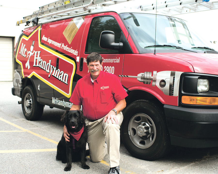 Tim Adams, owner of Mr. Handyman of Virginia Beach, <BR>and Quincy, the companyâ€™s beloved mascot.               <BR>Photo by Michele Thompson