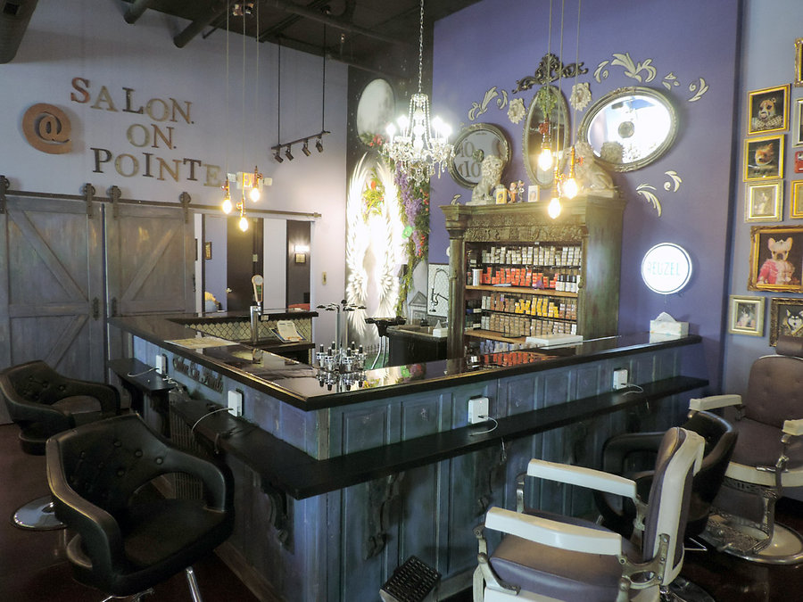 A glistening bar surrounded by antique barber chairs and illuminated by chandeliers creates but one of Salon on Pointeâ€™s many gorgeous focal points.